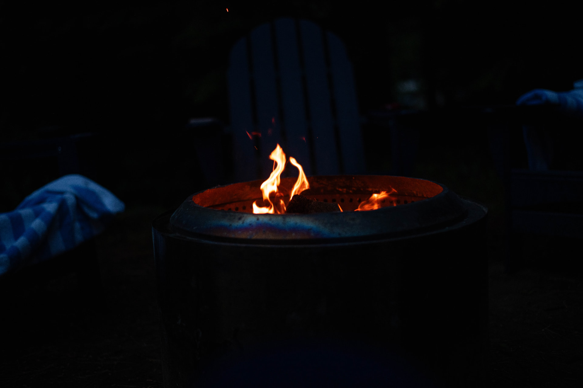 Fire burning in a firepit after dark